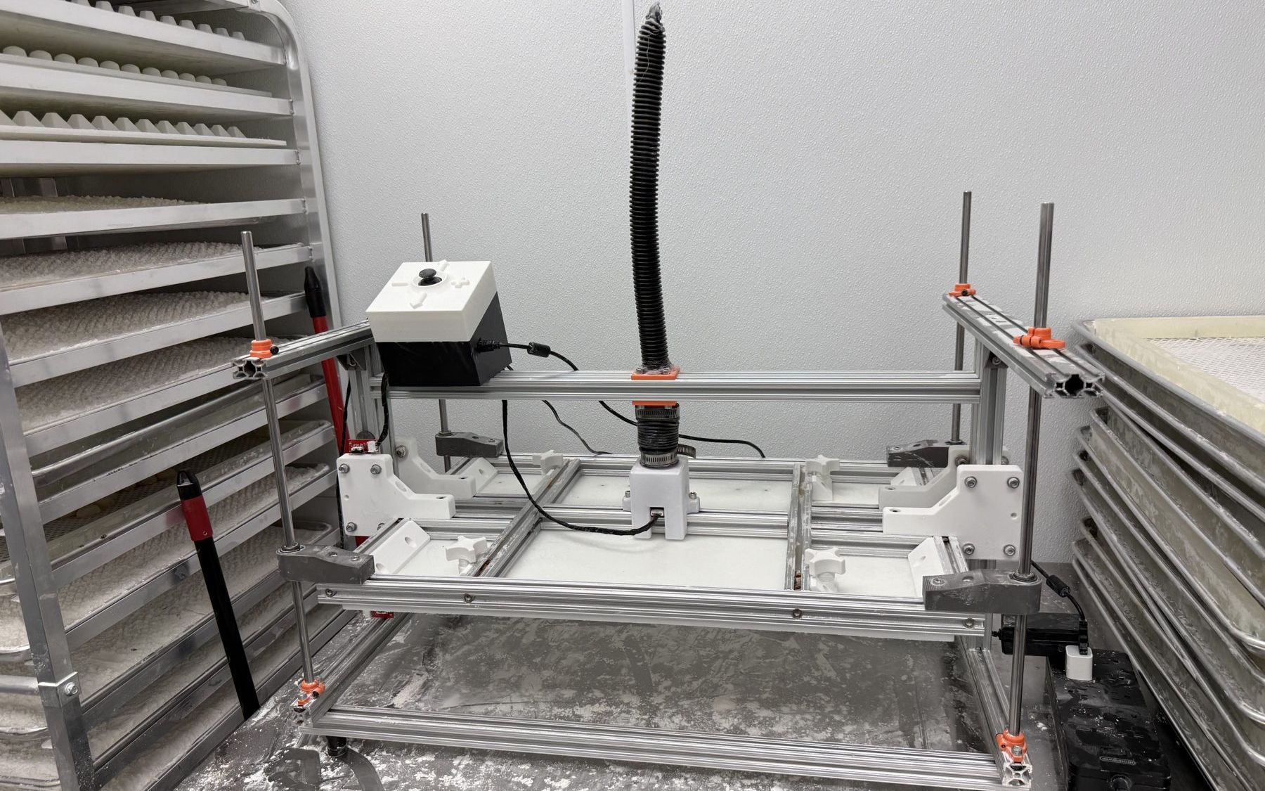 The motorized chocolate press on the workbench, three-quarter view